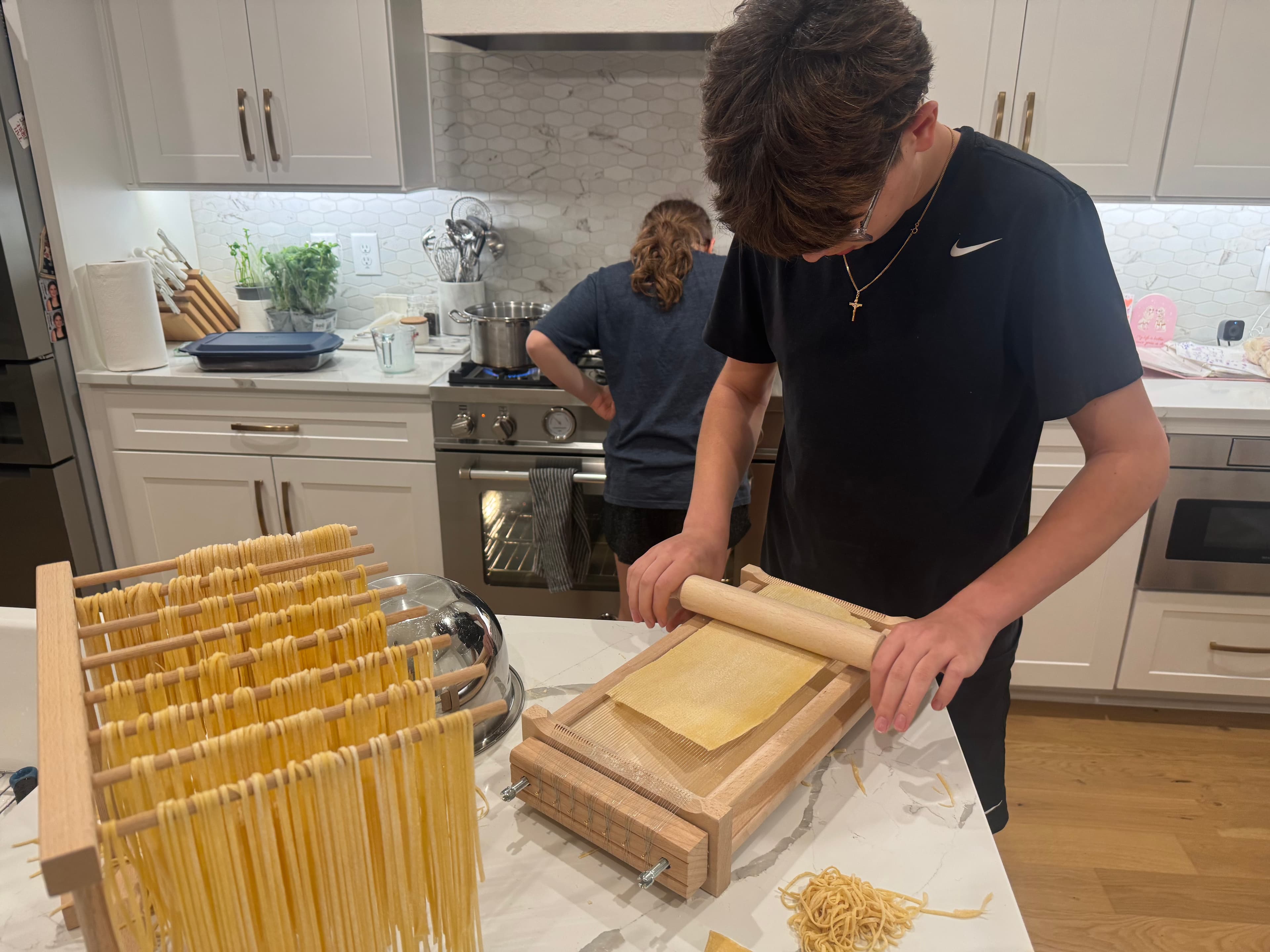 Kids shaping homemade pasta at a LIFE cooking experience